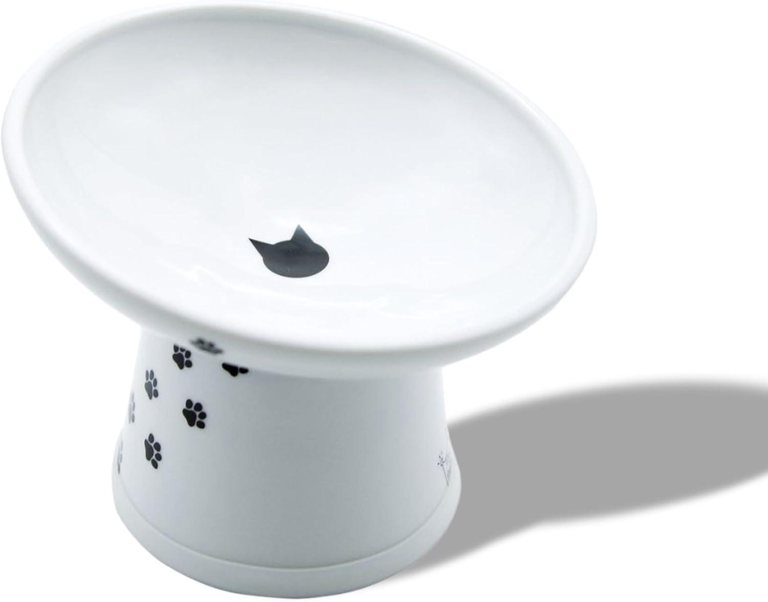 Elevated angled white ceramic food bowl with spill-proof inner lip.